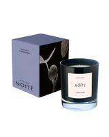 Candle with 'Atelier Noçté' packaging on a white background