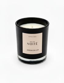 Black candle jar with a beige label on a white background