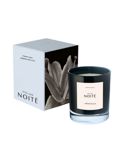 Black candle labeled 'Atelier Noité' with packaging on a white background