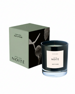 Candle with 'Atelier Noité' label and packaging on a white background