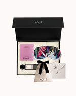 Atelier Noitē gift set with eye mask, pouch, and card on a white background