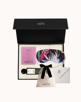 Atelier Noitē gift set with eye mask, pouch, and card on a white background