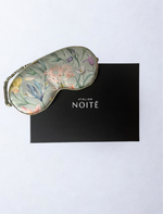 Green silk mask with floral tint on a black branded gift box