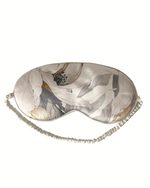Sleep mask with abstract leaf pattern on a white background