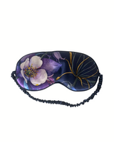 Floral patterned eye mask with black straps on a white background